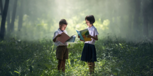 two children is reading while standing